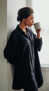 Woman drinking coffee looking out window