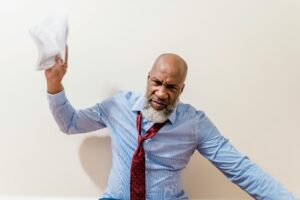 professional black man, skewed tie about to toss a paper - upset