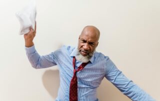 professional black man, skewed tie about to toss a paper - upset