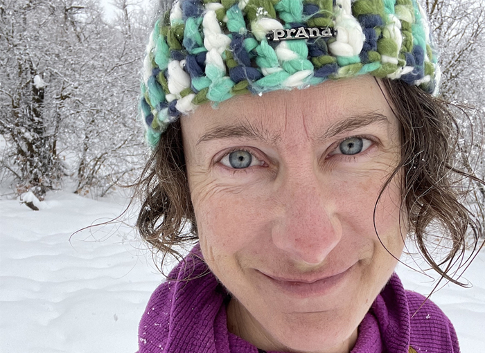 Andrea Feucht in winter Andrea Feucht smiling in a knit cap amid a snowy winter landscape winter