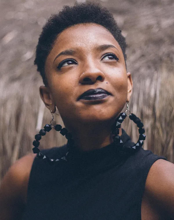 Confident woman looking up A confident young woman with short hair looking upward, evoking hope and resilience
