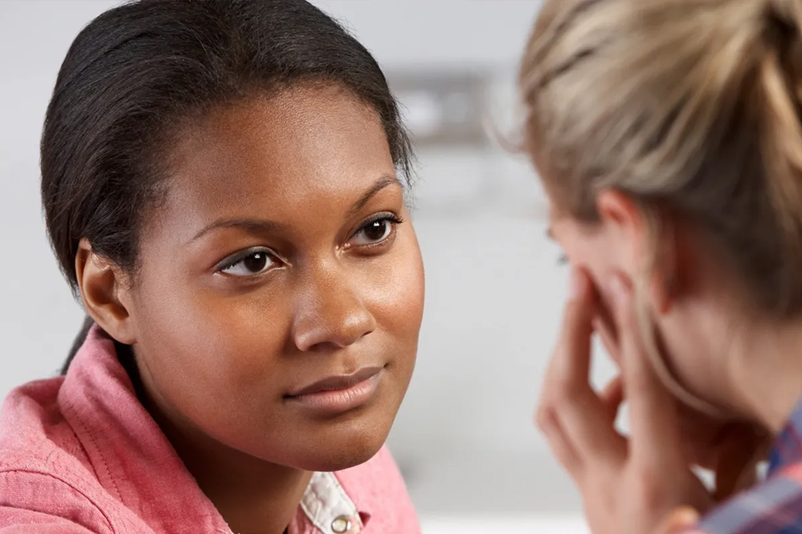 Counseling conversation A woman in conversation with another person during a counseling session