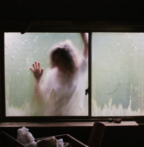 Figure behind frosted glass A blurred figure pressing against a fogged glass window, evoking dissociation and feeling trapped or unseen