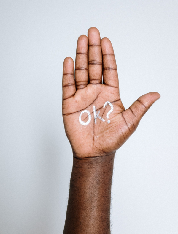 Open palm with OK written An open palm with the words OK question mark written on it, a gesture of checking in and consent
