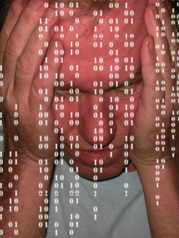 Overwhelmed by information A man holding his head as binary numbers cascade in front of him, evoking anxiety and information overload