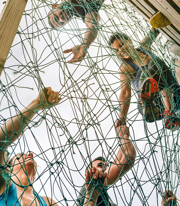 An abstract image of people linked by a web of glowing lines, evoking interconnection and systems