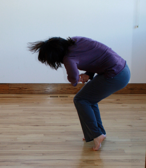 Sabrina Santa Clara moving in a dance studio Sabrina Santa Clara crouching and moving expressively in a studio, evoking authentic movement