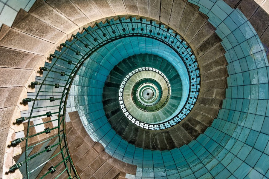 Spiral staircase from above View looking down a teal spiral staircase forming a fibonacci spiral, evoking sacred geometry