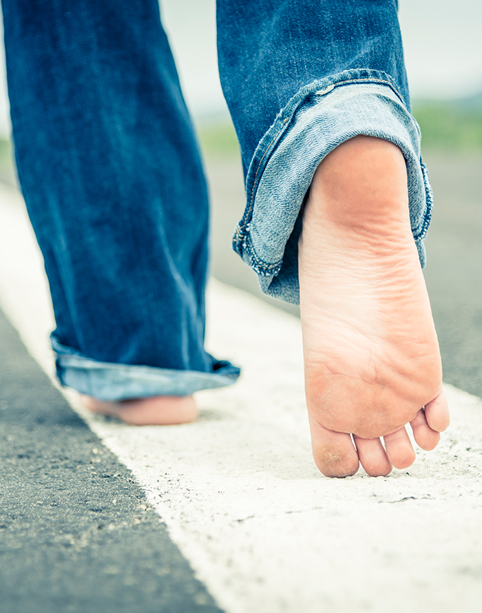 Walking a path Legs in jeans walking along a painted line, evoking taking steps forward on a path