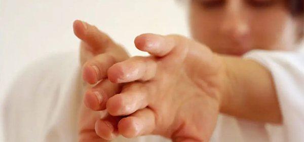 Hands in mindful movement A soft-focus image of a woman's hands touching in a ritual, mindful movement gesture