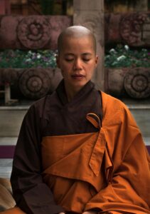 bald buddhist woman meditating